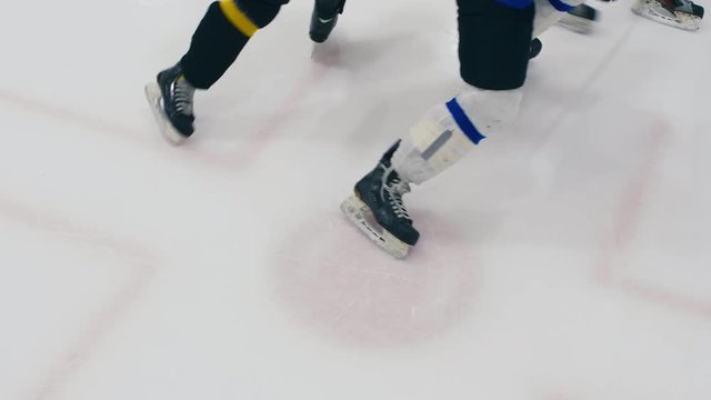 High angle shot of referee throwing puck to face-off on ice hockey game
