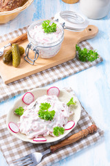 delicious homemade meat salad with mayonnaise and cucumber