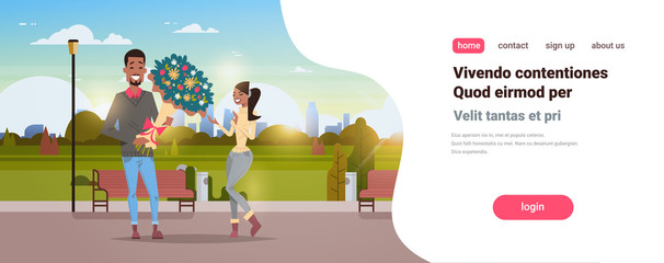 man present woman bouquet of flowers happy valentines day holiday concept african american couple in love city urban park cityscape background copy space horizontal