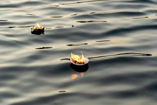 Hinduism religious ceremony puja flowers and candle on river Ganges water, India
