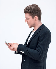 side view.successful businessman typing SMS on smartphone