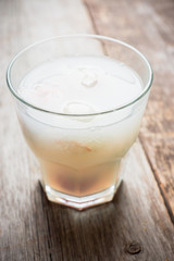 Old fahioned lychee cocktail on the rustic background. Selective focus. Shallow depth of field. 
