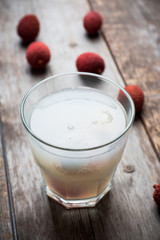 Old fahioned lychee cocktail on the rustic background. Selective focus. Shallow depth of field. 