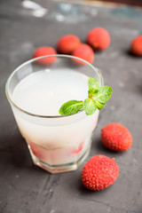 Old fahioned lychee cocktail on the rustic background. Selective focus. Shallow depth of field. 