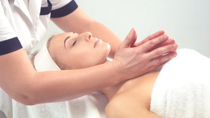 Young attractive woman getting spa treatment over white background.