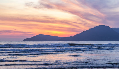 pink sunset over the sea with waves