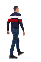 Back view of going  handsome man in sweater.