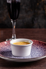 French cuisine concept. Creme brulee. Caramelization creme brulee using fire from pastry burner