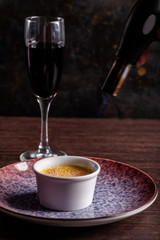 French cuisine concept. Creme brulee. Caramelization creme brulee using fire from pastry burner