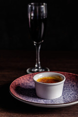 French cuisine concept. Creme brulee. Caramelization creme brulee using fire from pastry burner