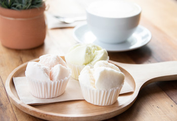 Hot coffee with sweet cake ready to drink on wood table background