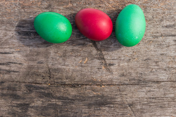 Painted Easter eggs on rustic wooden background