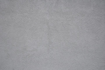 Very light grey painted grunge plaster wall as abstract textured background.