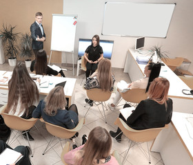 confident businessman explaining something on whiteboard during conference