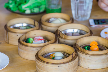The background of food that is put in a wooden container (dim sum) containing vegetables, pork, flour Used to make, a menu that requires steaming stoves for good taste, delicious to eat 