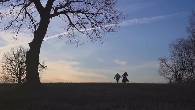 Grim Reaper came for a new victim and leads the victim to death. sunset silhouette. concept of death