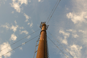 Tall tower. Antenna for receiving a signal. Technical cooperation of the past era. Rusty pipe....