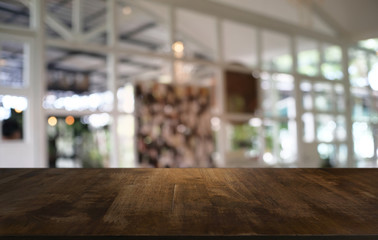 Empty dark wooden table in front of abstract blurred bokeh background of restaurant . can be used for display or montage your products.Mock up for space.