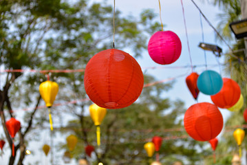 Fototapeta na wymiar Paper lanterns in a traditional street in Vietnam. Tet festival decoration