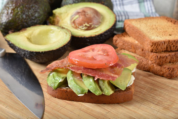 Avocado sandwich with bacon and tomato