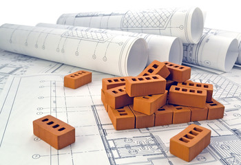 Photos of project drawings and brown bricks 