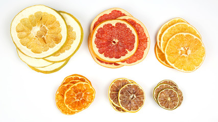 mix of different pieces of dried citrus fruit on white background