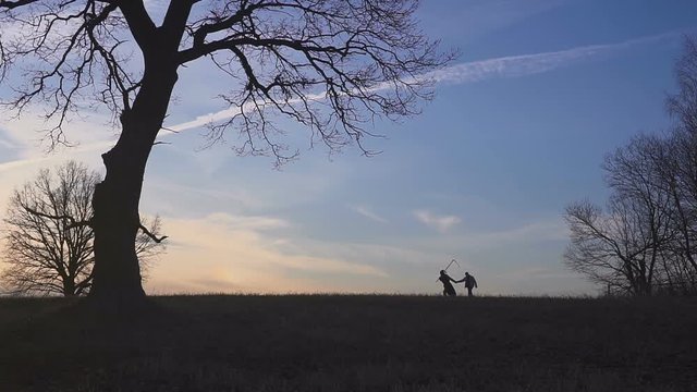 Grim Reaper came for a new victim and leads the victim to death. sunset silhouette. concept of death