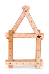 Wooden folding inch ruler in the shape of two house. Isolated on white background. Clipping path included.