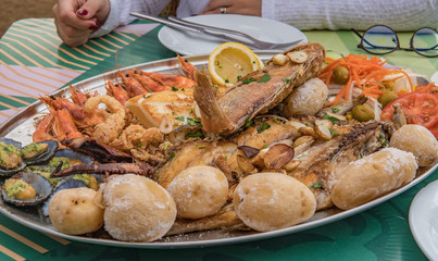 Tasty grilled fish on plate with vegetables