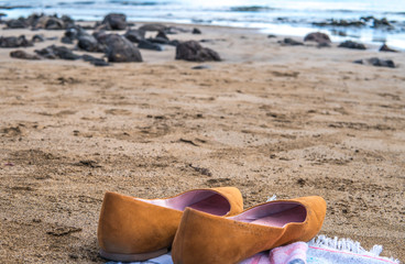 Vacation concept - summer shoe on the beach