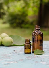Walnut oil in a bottle and green nuts. Selective focus