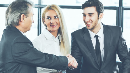 shaking hands during a business meeting business partners