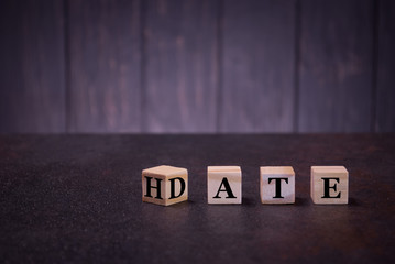 The word date hate on wooden cubes, on a dark background, light wooden cubes signs, symbols signs, business office, site content, still life