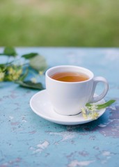 White cup and dish of linden,  Herbal medicine concept. 