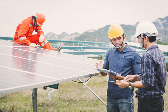 Engineer In Solar Power Plant Working On Installing Solar Panel ; Operation Of Solar Power Plant By Smart Operator