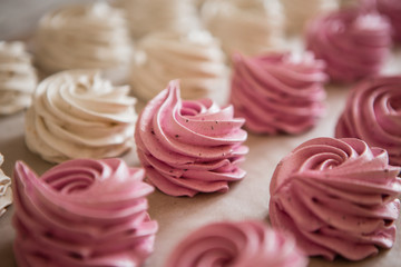 handmade marshmallows in pink and white are lying on the table in close-up. place for text, postcard