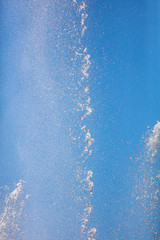 Obraz na płótnie Canvas Splashes of water against the blue sky