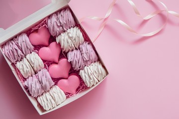 handmade marshmallows in pink and white in a gift box are lying on the table in close-up. place for text, postcard