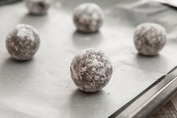 freshly baked chocolate cookies sprinkled with powdered sugar close-up