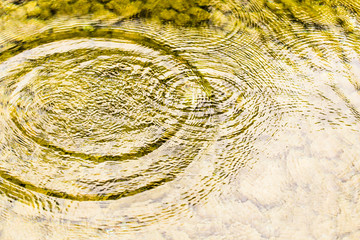 Circles on the surface of the reservoir as a background