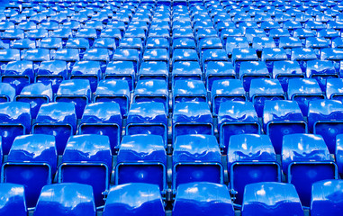 Many bright blue stadium seats perspective shot