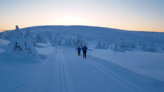 Cross country skiers during sunrise in Lillehammer norway.