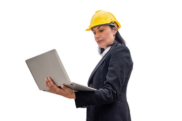 Woman engineer with yellow helmet holding laptop on background
