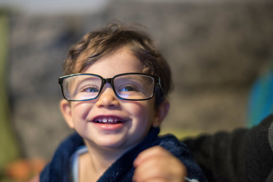 Baby with big eyeglasses smiling