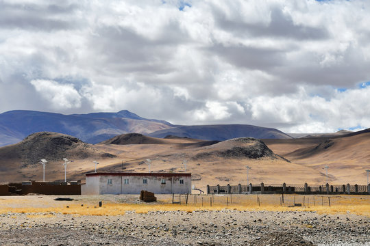 Tibet. One-storey building on the shore of lake Tarok in summer in cloudy day