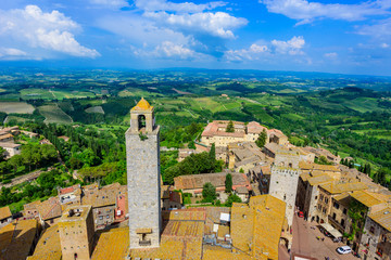 Fototapeta na wymiar San Gimignano - Aerial view of the historic town with beautiful landscape scenery on a sunny summer day in Tuscany, small walled medieval hill town with towers in the province of Siena, Italy