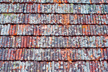 Roof tiles texture. Old weathered clay shingle roof.