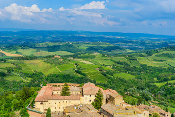Fototapeta na wymiar San Gimignano - Aerial view of the historic town with beautiful landscape scenery on a sunny summer day in Tuscany, small walled medieval hill town with towers in the province of Siena, Italy