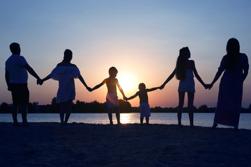 Silhouette of family on sunset background