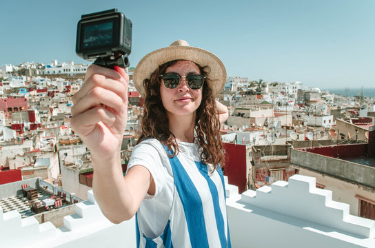 Young happy woman taking selfie on the terrace. Tourist enjoying a vacation in Tangier, Morocco
